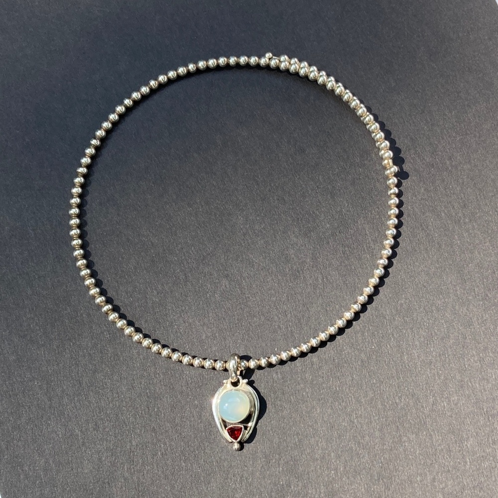 Sterling silver cuff necklace with pendant.